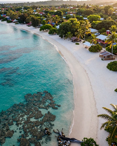 Aerial view of Roatán island Honduras with crystal-clear turquoise water and white sand beach