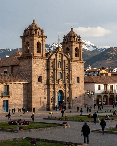 Historic Plaza de Armas in Cusco Peru with colonial cathedral and Incan stonework under golden light