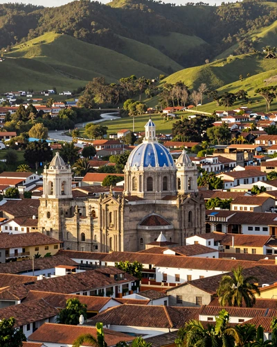 Panoramic view of Cuenca Ecuador with its blue-domed cathedral, terracotta rooftops, and green valley